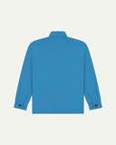 Reverse of bright blue buttoned organic cotton workshirt from Uskees showing reinforced elbows, tailored cuffs and boxy silhouette.