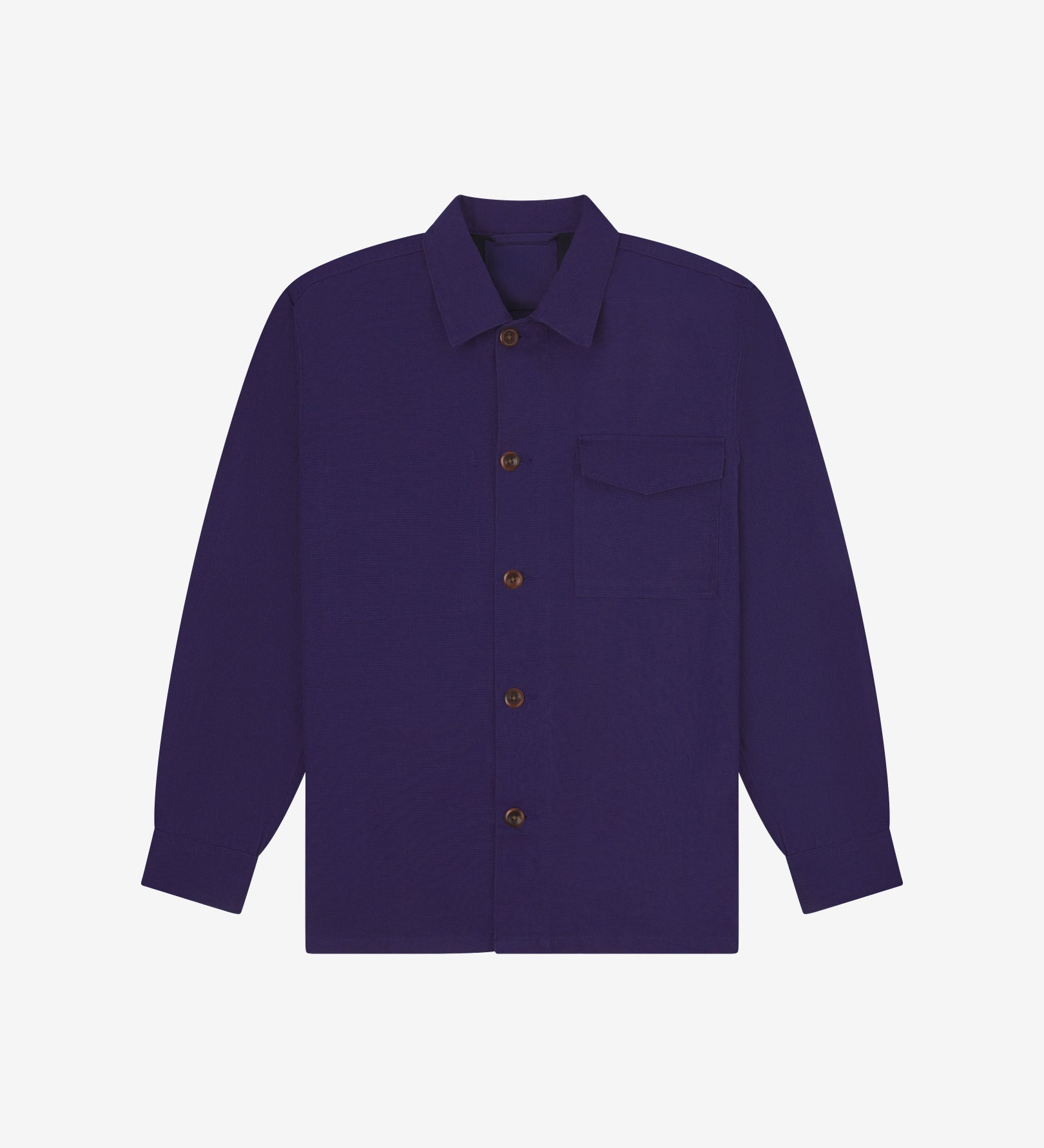 Deep indigo buttoned organic cotton workshirt from Uskees with clear view of chest pocket and utilitarian silhouette.