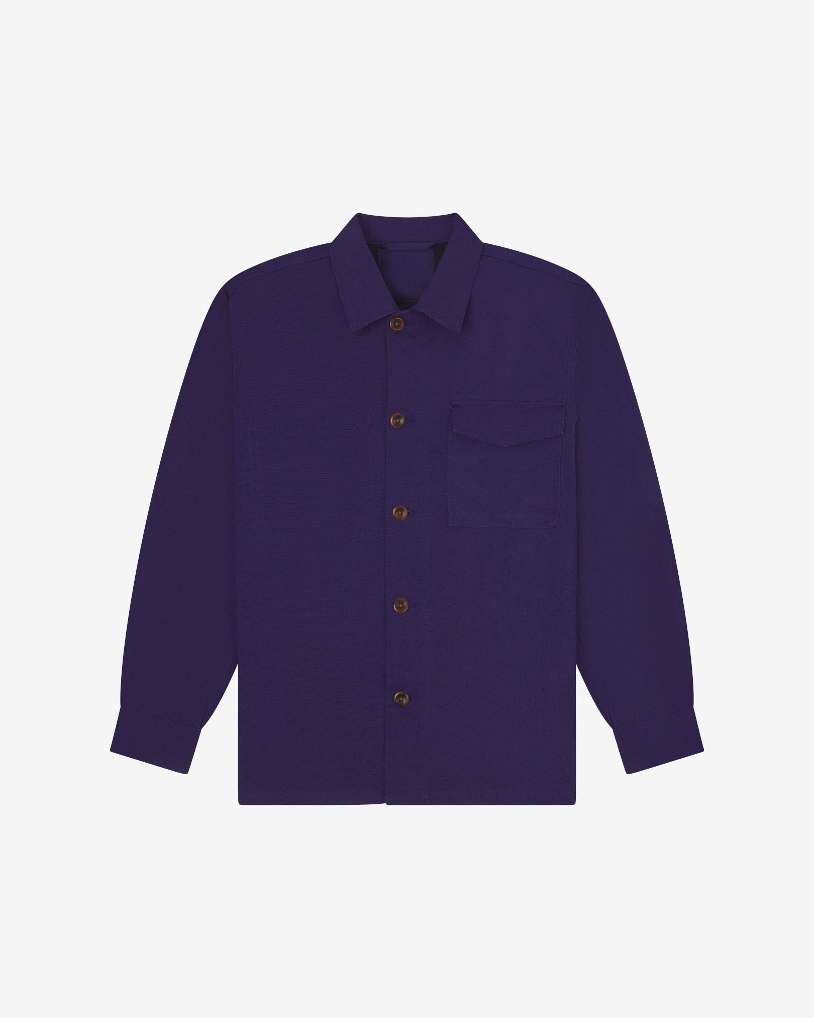 Deep indigo buttoned organic cotton workshirt from Uskees with clear view of chest pocket and utilitarian silhouette.