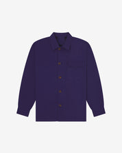 Deep indigo buttoned organic cotton workshirt from Uskees with clear view of chest pocket and utilitarian silhouette.