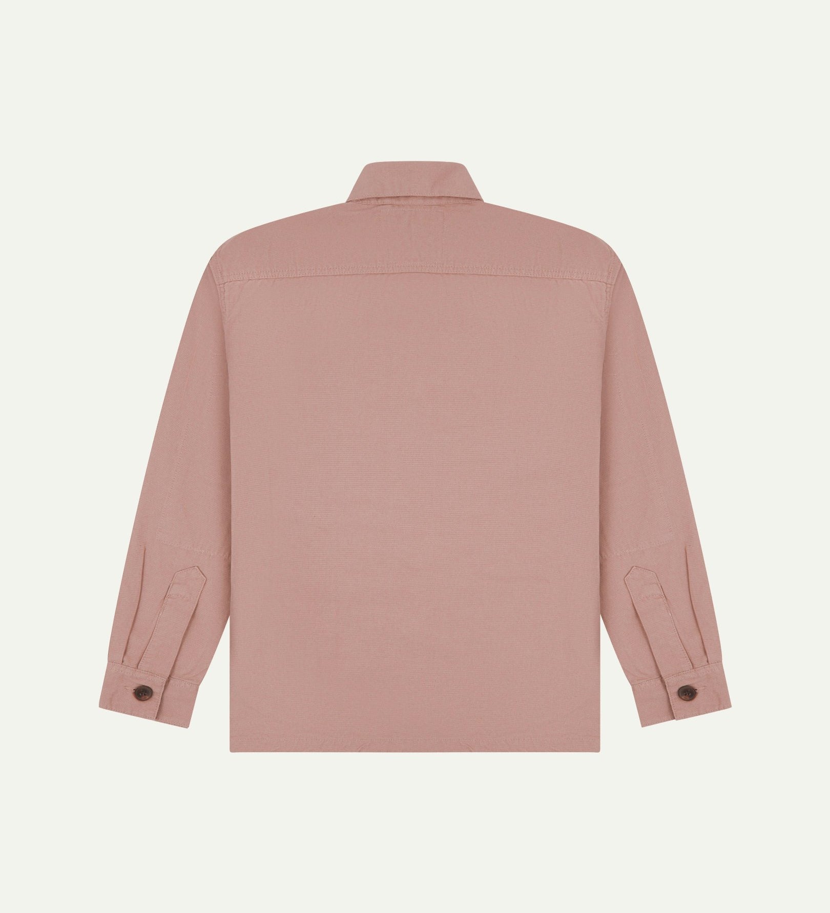 Reverse of dusty pink buttoned organic cotton workshirt from Uskees showing reinforced elbows, tailored cuffs and boxy silhouette.