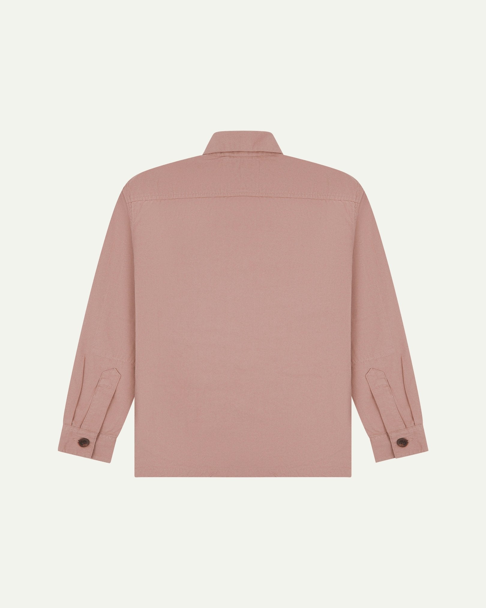 Reverse of dusty pink buttoned organic cotton workshirt from Uskees showing reinforced elbows, tailored cuffs and boxy silhouette.