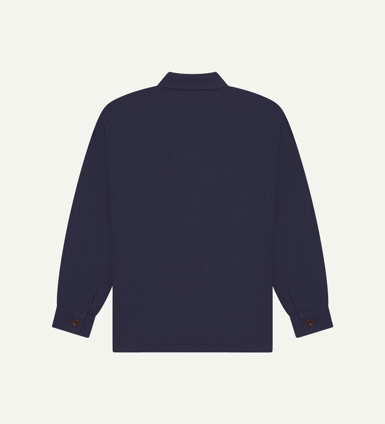 Reverse of midnight blue buttoned organic cotton workshirt from Uskees showing reinforced elbows, tailored cuffs and boxy silhouette.