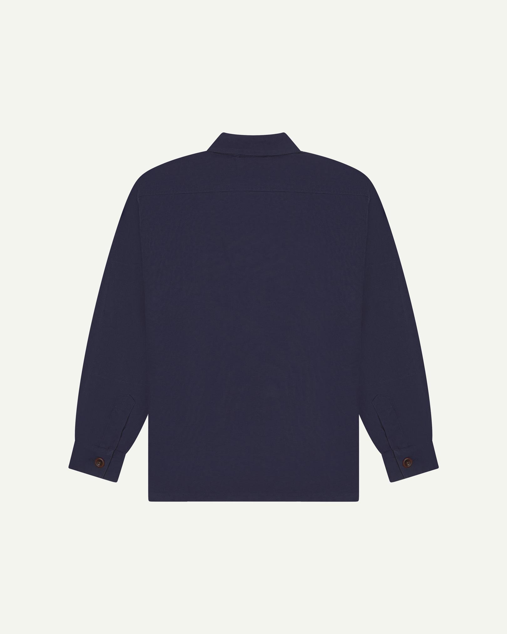 Reverse of midnight blue buttoned organic cotton workshirt from Uskees showing reinforced elbows, tailored cuffs and boxy silhouette.