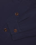 View of the mid-section and sleeve of the 3003 Uskees button-down work shirt in midnight blue with focus on cuff, placket and corozo buttons.