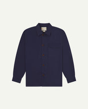 Midnight blue buttoned organic cotton workshirt from Uskees with clear view of chest pocket and Uskees branding label.