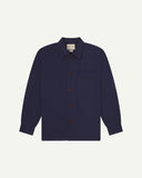 Midnight blue buttoned organic cotton workshirt from Uskees with clear view of chest pocket and Uskees branding label.