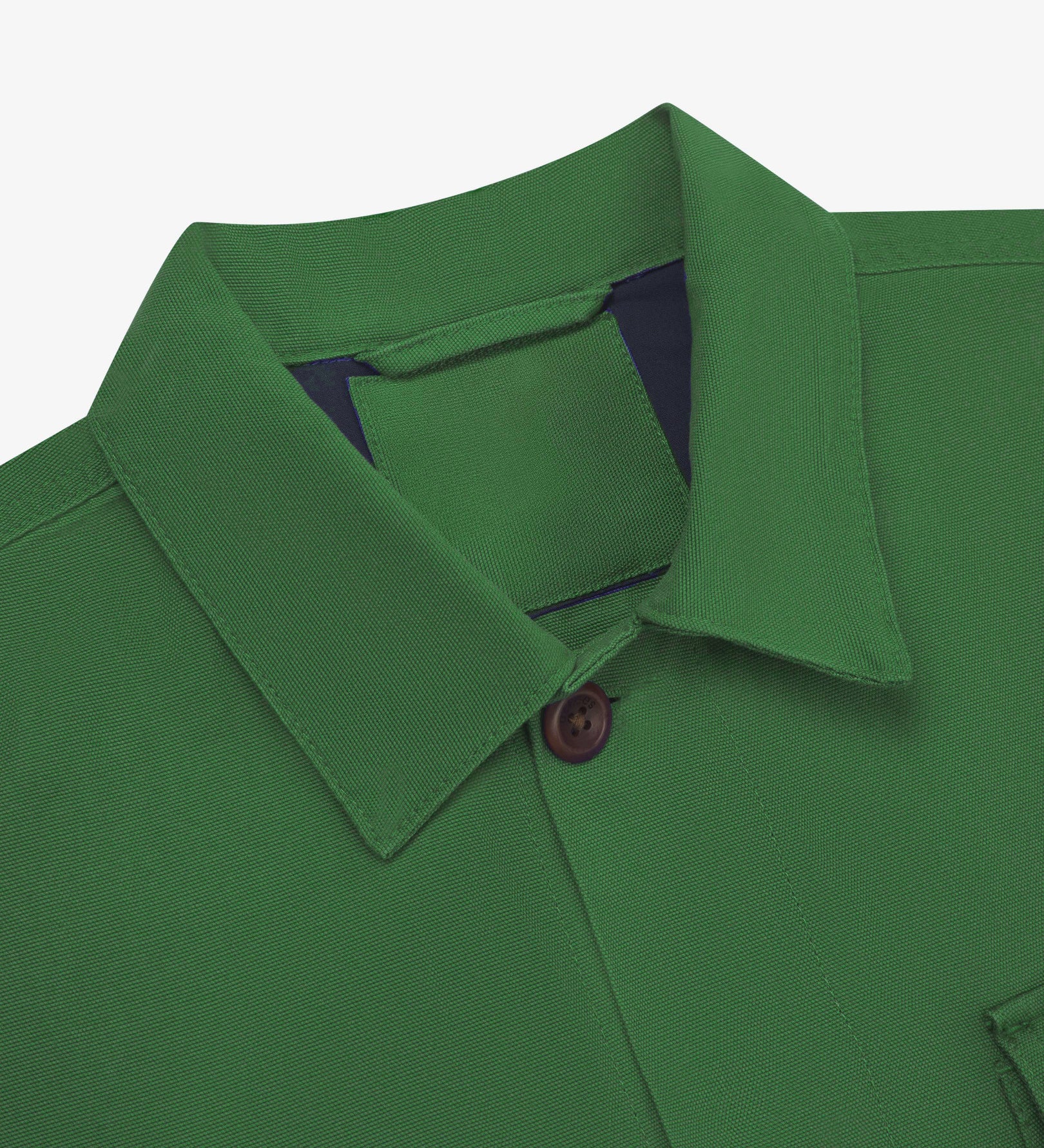 Close-up top-half view of #3003, mint green organic cotton workshirt. With focus on collar, Uskees brand label and corozo buttons.