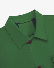 Close-up top-half view of #3003, mint green organic cotton workshirt. With focus on collar, Uskees brand label and corozo buttons.