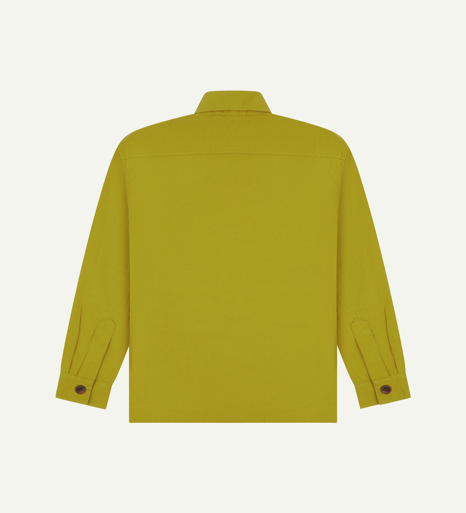 Reverse of yellow-green (pear) buttoned organic cotton workshirt from Uskees showing reinforced elbows, tailored cuffs and boxy silhouette.