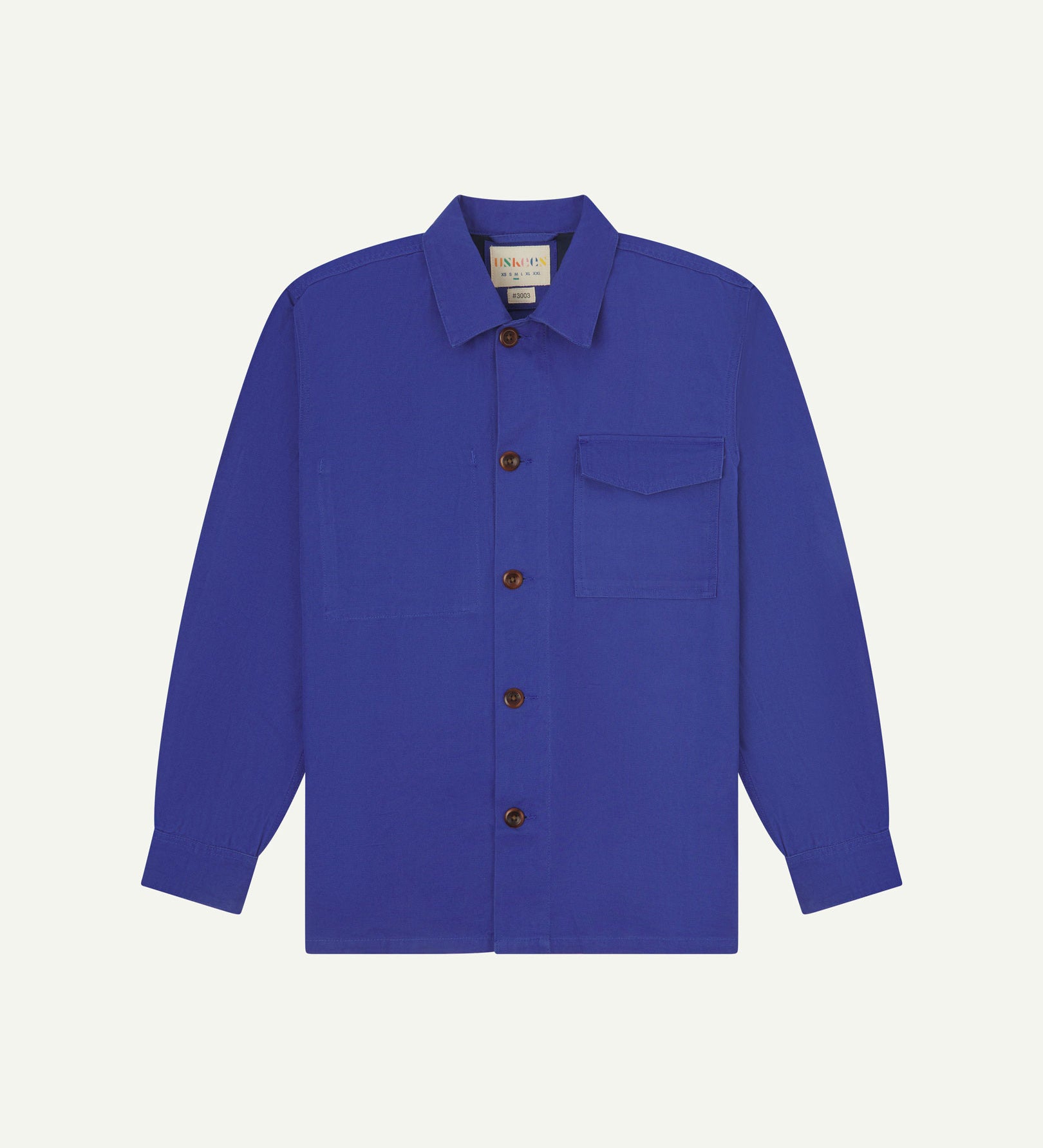 Ultra blue buttoned organic cotton workshirt from Uskees with clear view of chest pocket and Uskees branding label.