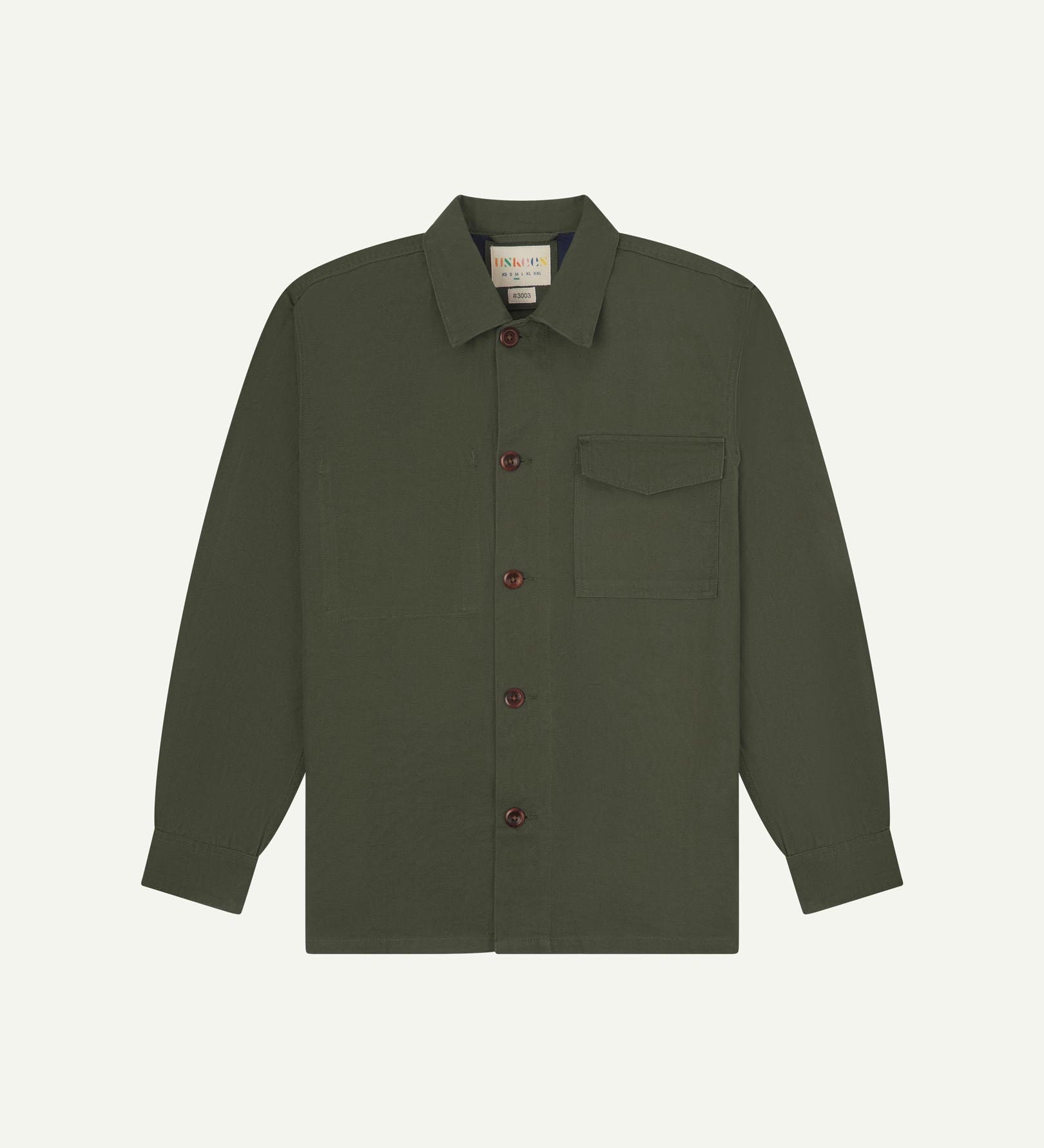 Vine green buttoned organic cotton workshirt from Uskees with clear view of chest pocket and Uskees branding label.