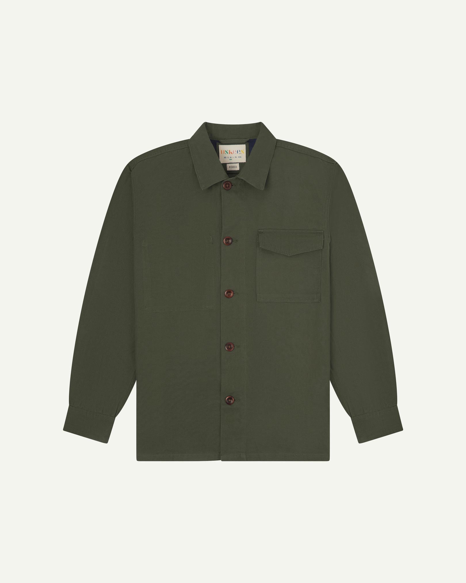 Vine green buttoned organic cotton workshirt from Uskees with clear view of chest pocket and Uskees branding label.