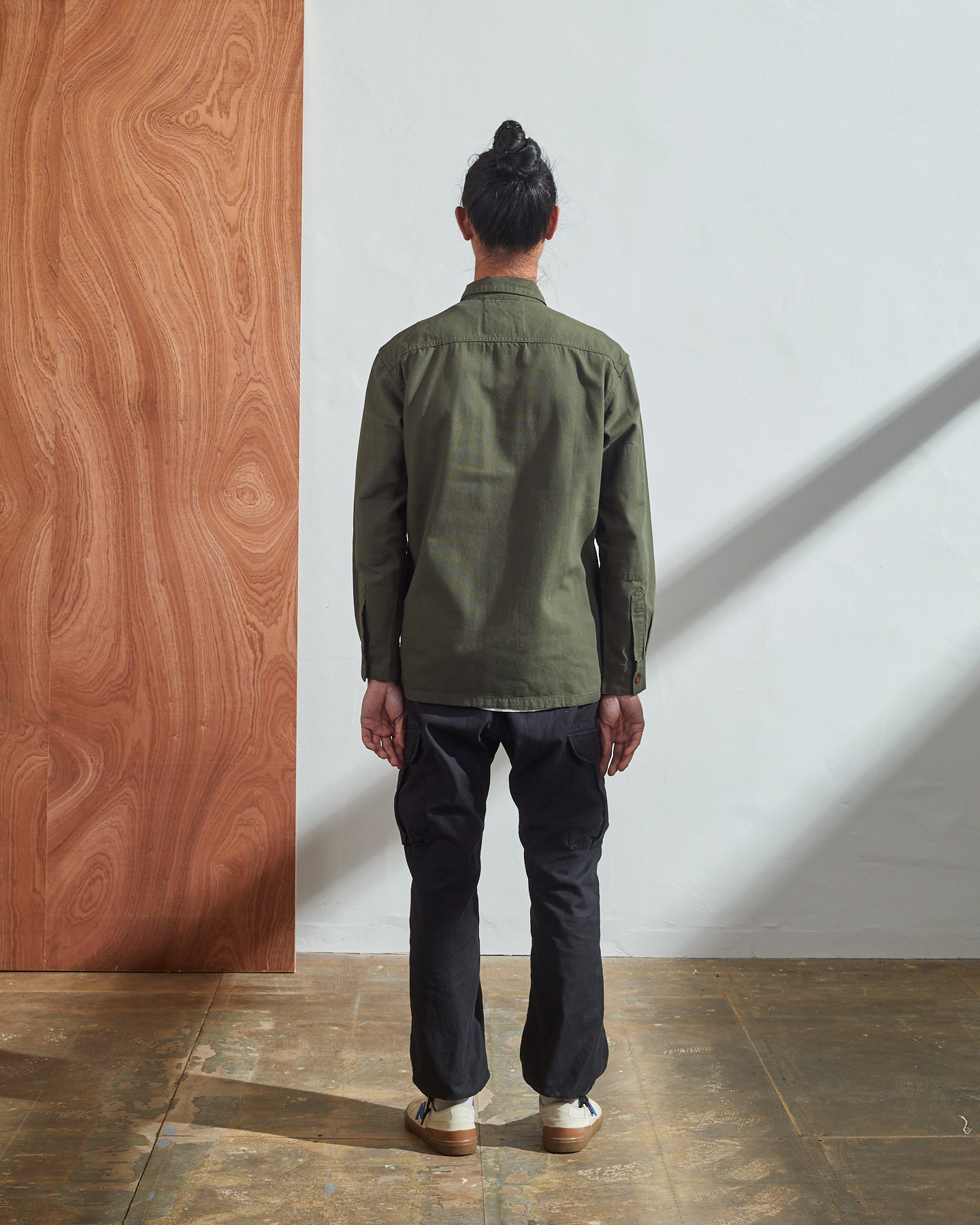 Full-length back view of 3003 vine green button-down work shirt showing reinforced elbows and simple silhouette.