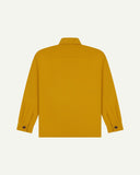 Reverse of yellow buttoned organic cotton workshirt from Uskees showing reinforced elbows, tailored cuffs and boxy silhouette.