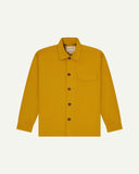 Yellow buttoned organic cotton workshirt from Uskees with clear view of chest pocket and Uskees branding label.