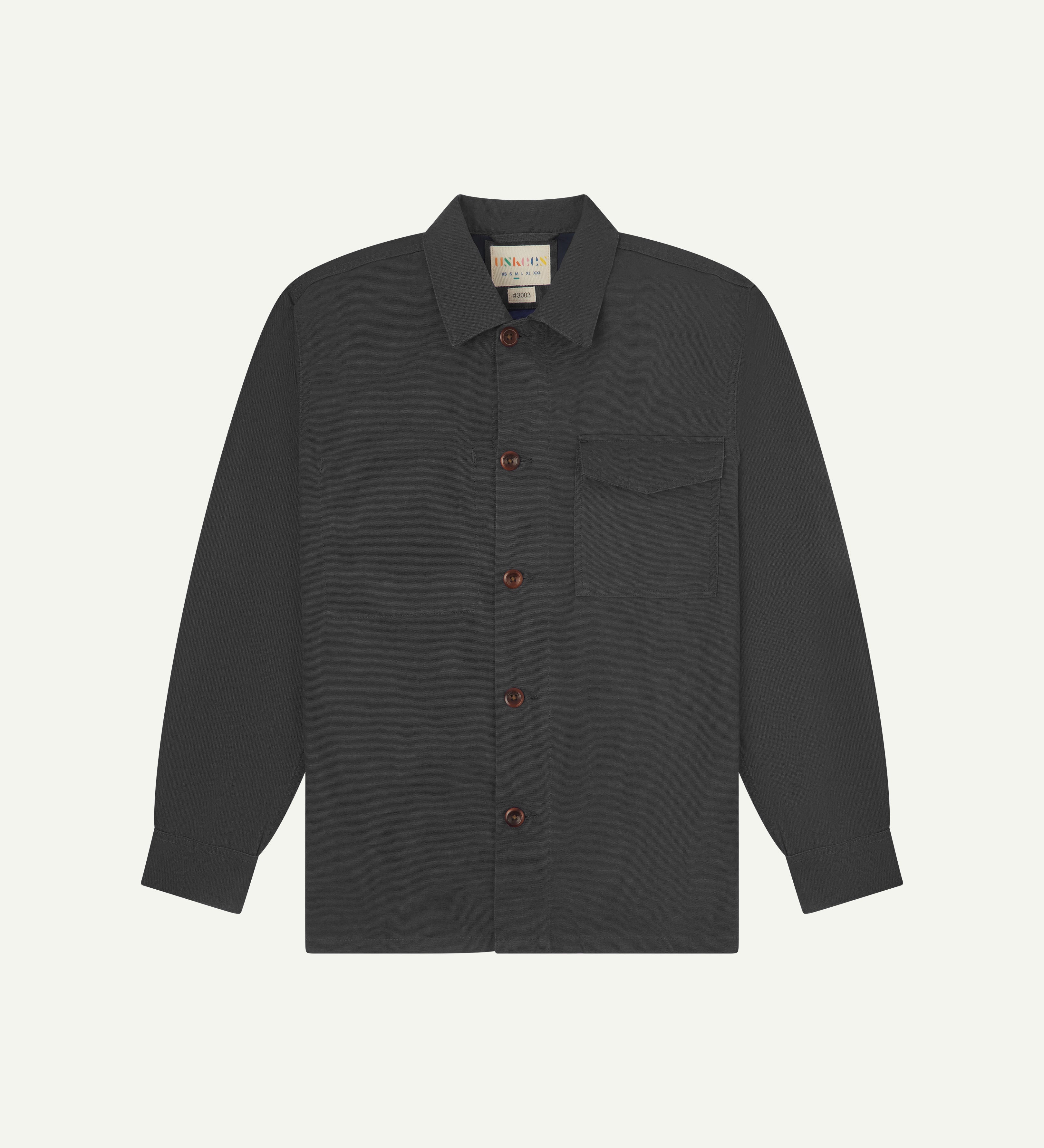 Front flat view of dark grey buttoned 3003 workshirt from Uskees. Showing breast pocket, navy yoke lining and brown corozo buttons