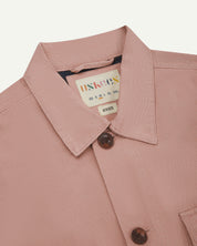 Front close-up shot of pale pink buttoned 3003 workshirt from Uskees. Showing collar, dark blue lining, brand/size label and corozo buttons.