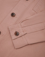 Close-up front shot of pale pink buttoned 3003 workshirt from Uskees. Showing sleeve/cuff detail and brown corozo buttons.