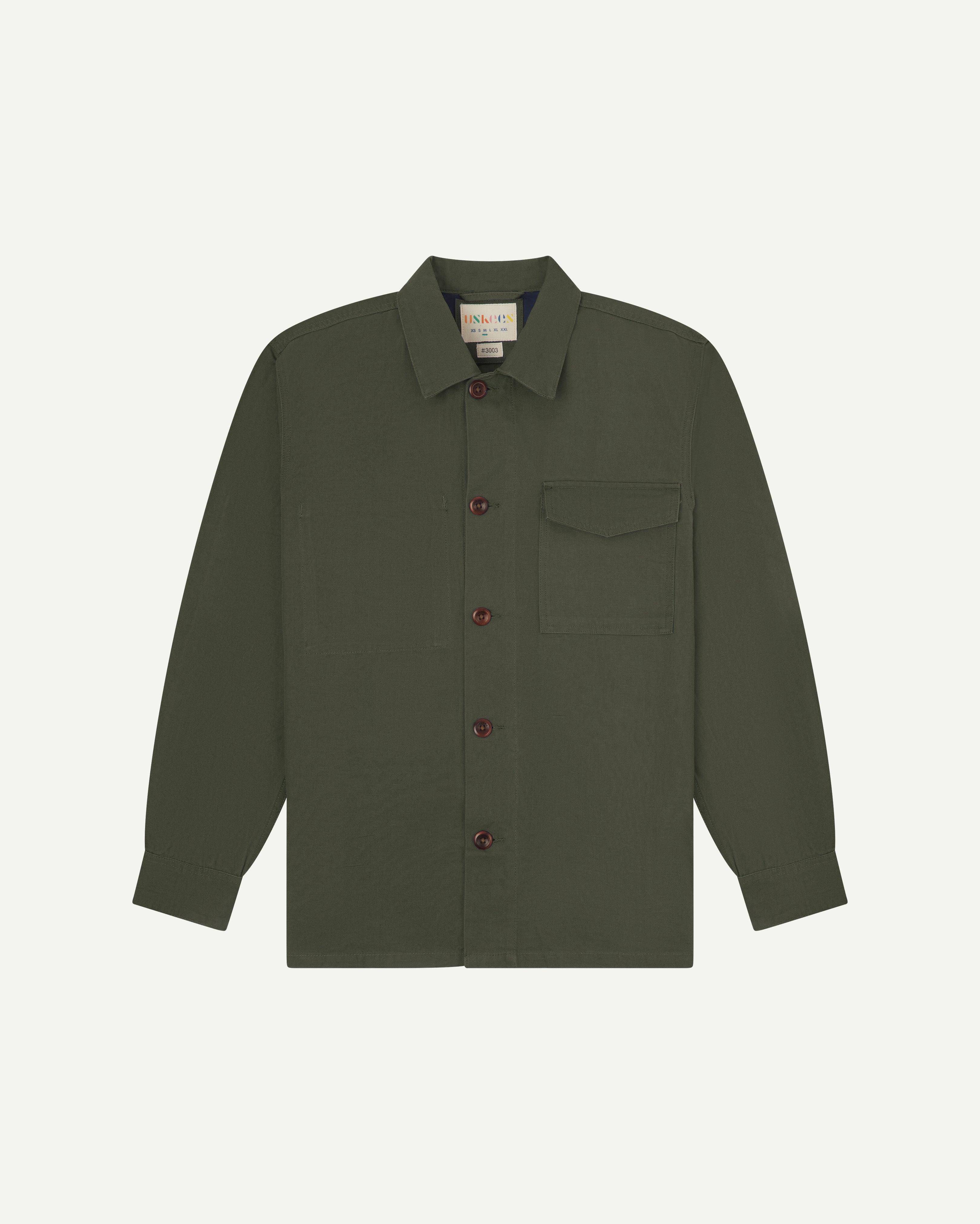 Front flat shot ofdull green #3003 men's workshirt from Uskees. Showing chest pocket with flap and corozo buttons.