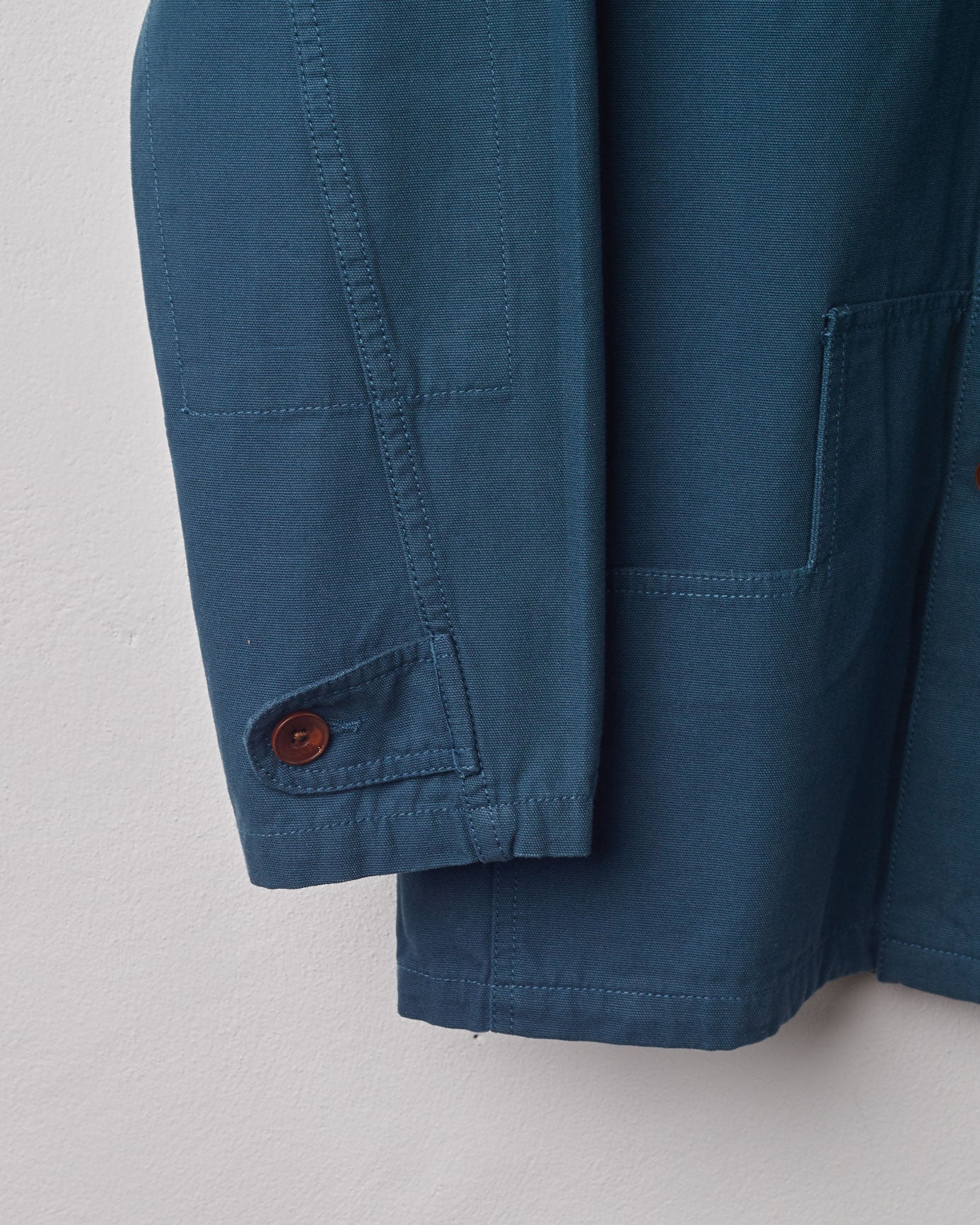 Close-up of #3004 Uskees peacock coloured button jacket showing cuff detail with brown Corozo button