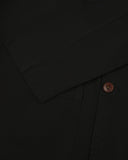 Close-up view of cuff and placket of organic cotton, black blazer from Uskees.