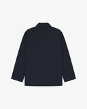 Reverse of dark blue (blueberry) buttoned organic cotton-drill blazer from Uskees showing reinforced elbows and boxy silhouette.