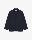 Dark blue (blueberry) buttoned organic cotton-drill blazer from Uskees with clear view of three patch pockets and Uskees branding label.
