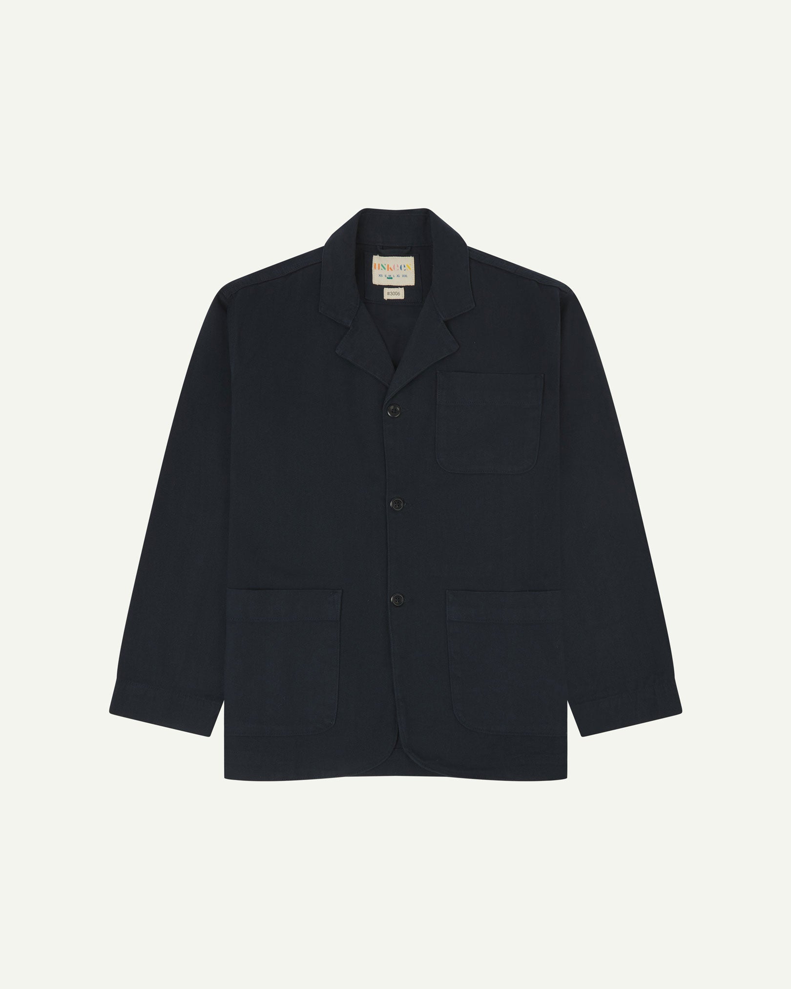 Dark blue (blueberry) buttoned organic cotton-drill blazer from Uskees with clear view of three patch pockets and Uskees branding label.