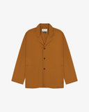 Full front view of buckthorn (mustard yellow) buttoned organic cotton-drill blazer from Uskees with notch lapels, a three-button front closure, three patch pockets and Uskees branding label.