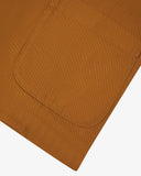 Closer detail view of hip patch pocket, hemline and the extra durable weave of the organic cotton buckthorn (mustard yellow) drill fabric.