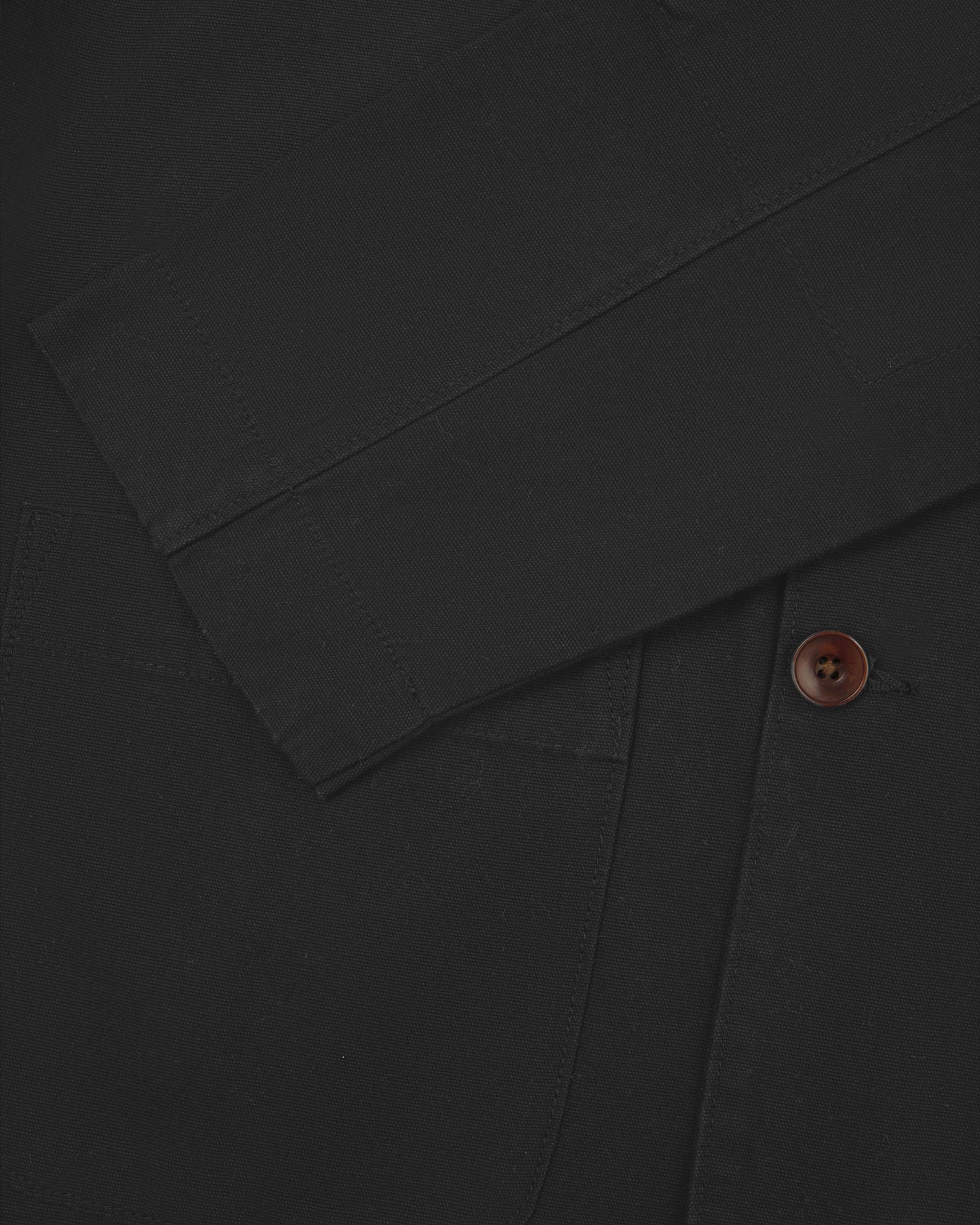 Close-up view of cuff and placket of organic cotton, charcoal grey blazer from Uskees.