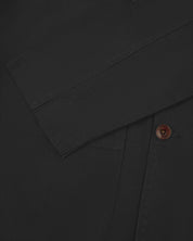 Close-up view of cuff and placket of organic cotton, charcoal grey blazer from Uskees.