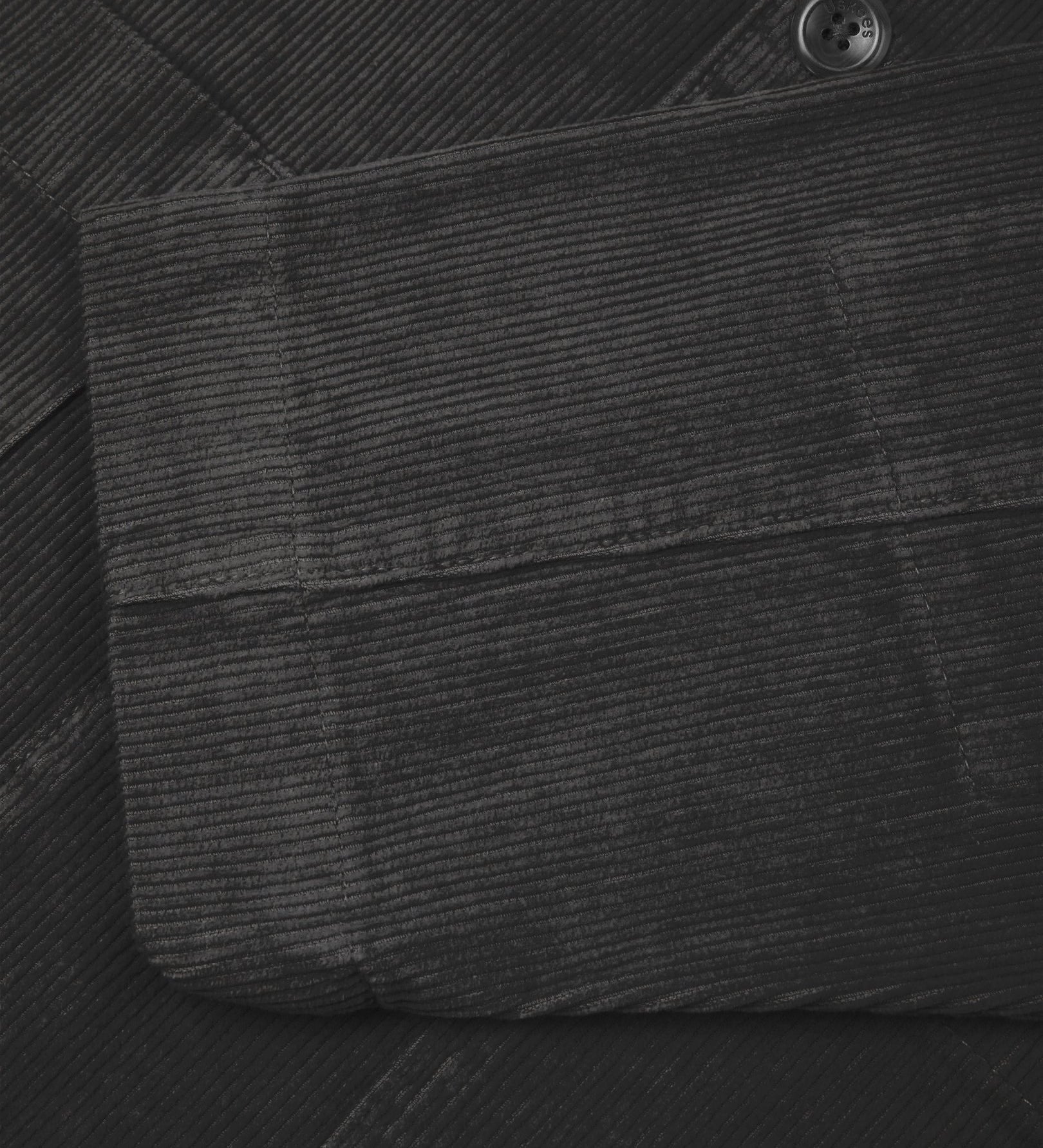 Close-up view of cuff, placket and corozo buttons of charcoal-grey blazer from Uskees and providing a clearer view of the 11 wale organic corduroy.