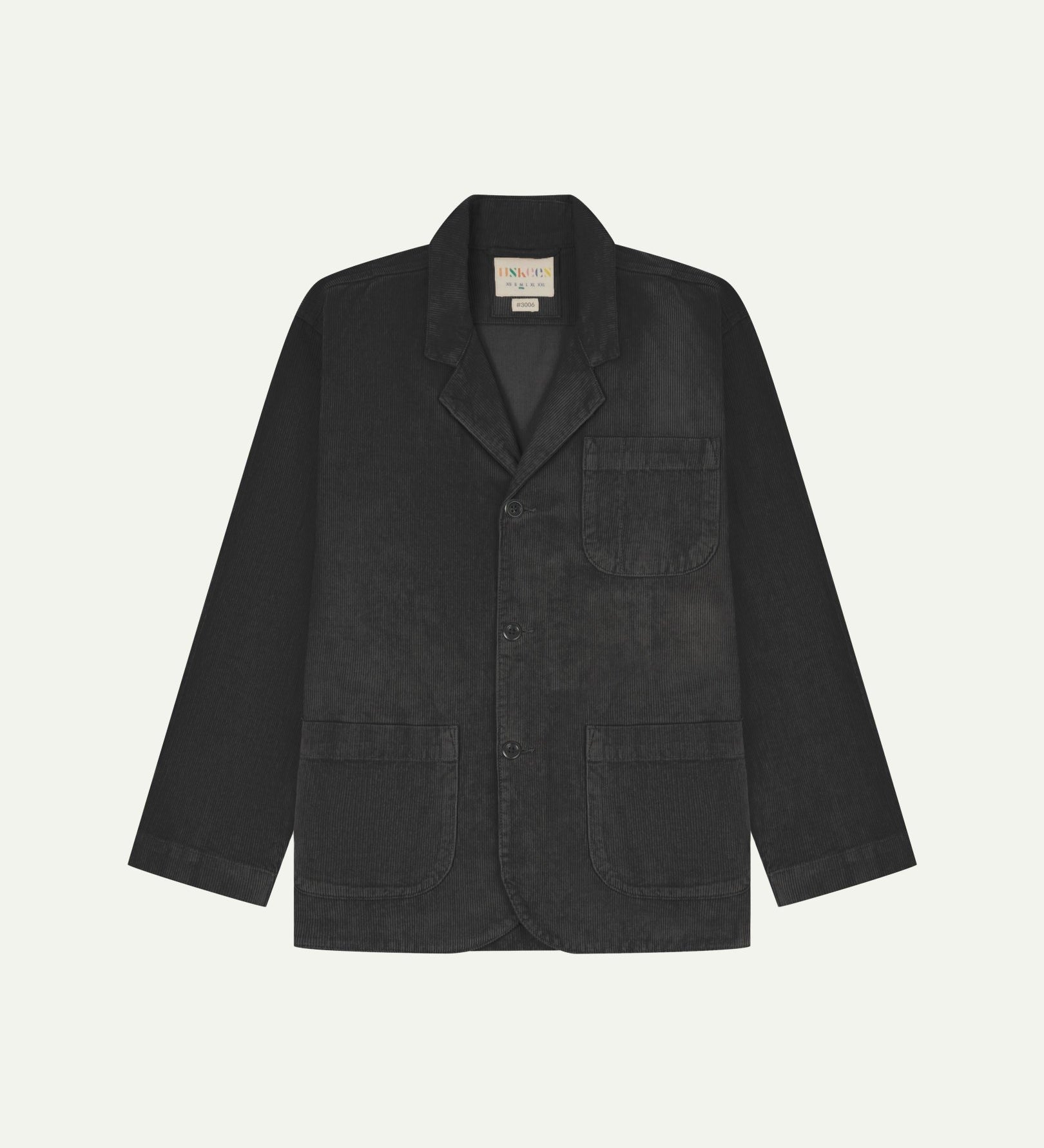 Flat front view of corduroy charcoal-grey blazer with 3 patch pockets from Uskees. Clearly showing corozo buttons and 3 pockets.
