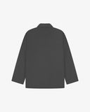 Reverse of charcoal-grey buttoned organic cotton-drill blazer from Uskees showing reinforced elbows and boxy silhouette.