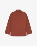 Reverse of chestnut-brown buttoned organic cotton-drill blazer from Uskees showing reinforced elbows and boxy silhouette.