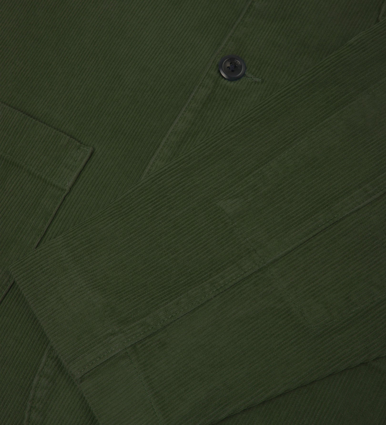 Close-up view of cuff, placket and corozo buttons of organic corduroy, coriander-green blazer from Uskees.