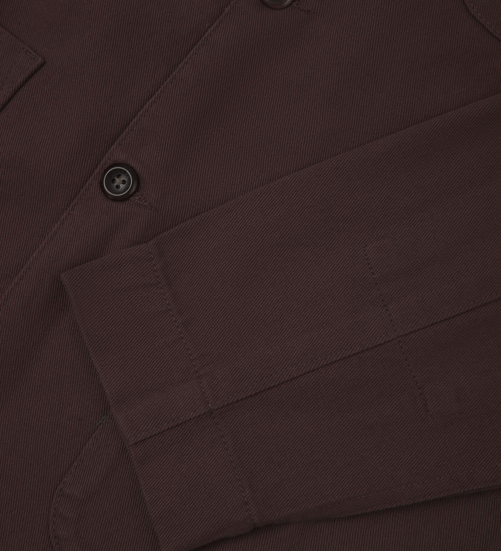 Closer detail view of patch pockets, cuff detailing, corozo buttons and extra durable weave of the organic cotton drill fabric.