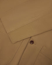 Close-up view of cuff and placket of organic cotton, khaki green blazer from Uskees.