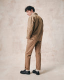 Full-length back view of man wearing the 3006 khaki blazer from Uskees, paired with matching khaki workwear pants.