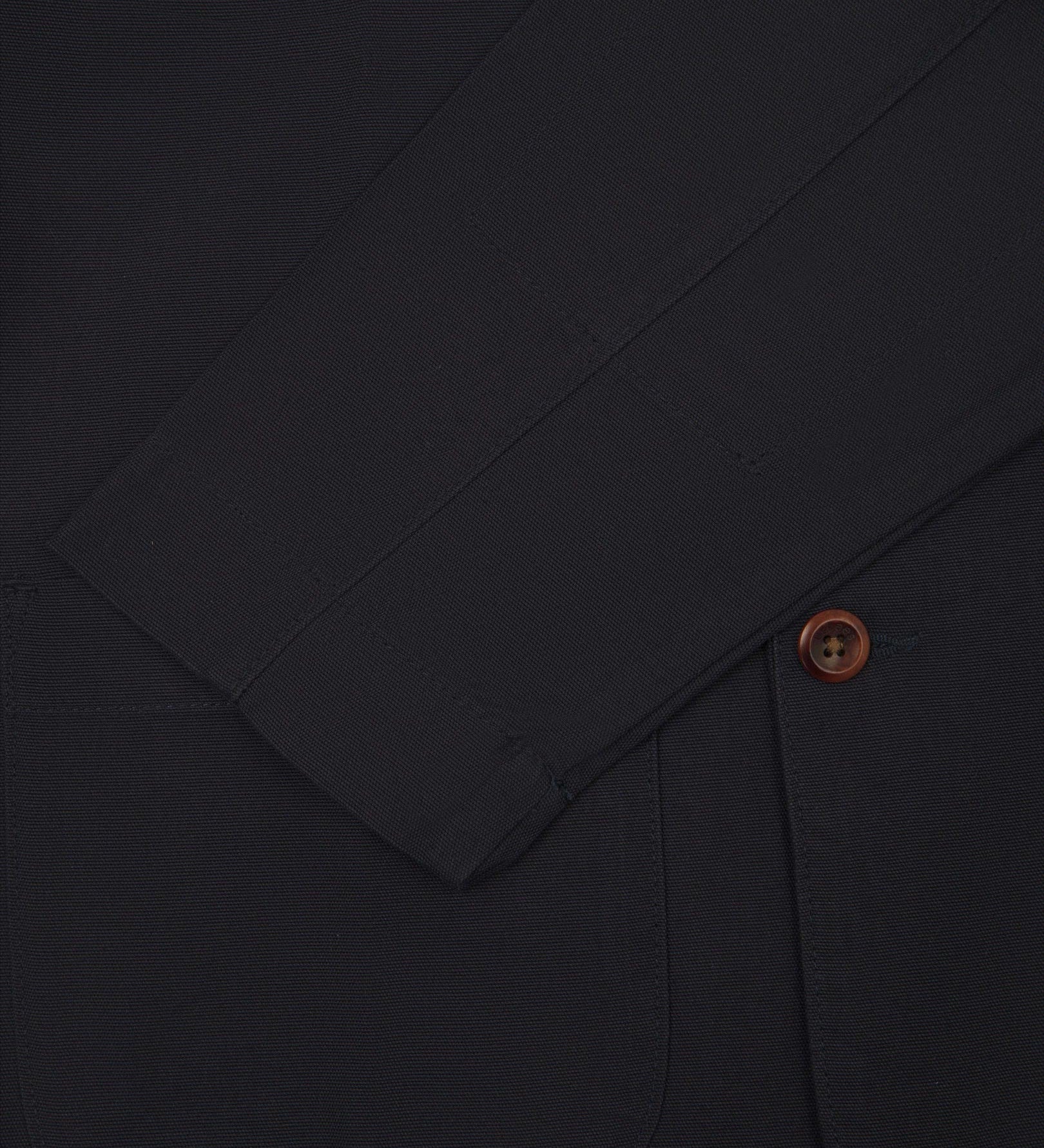 Close-up view of cuff and placket of organic cotton, midnight blue blazer from Uskees.