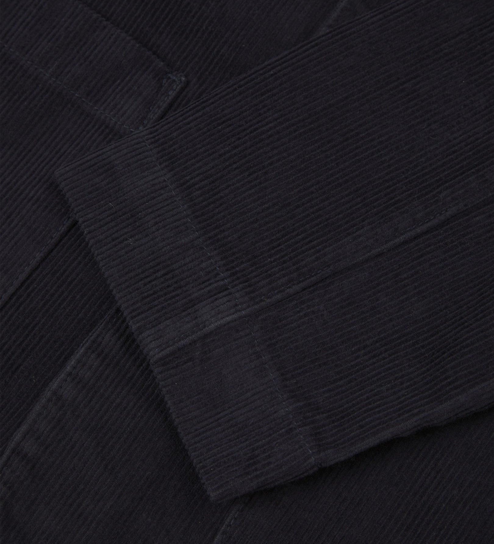 Close-up view of cuff and placket of organic corduroy, midnight blue blazer from Uskees.