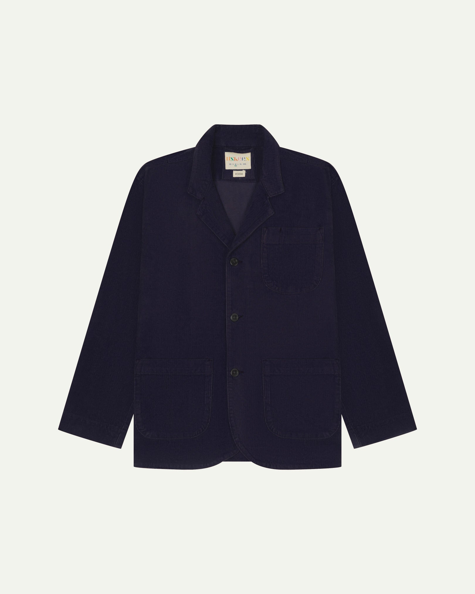 Flat front view of corduroy midnight blue blazer with 3 patch pockets from Uskees. Clearly showing corozo buttons and 3 pockets on the front.