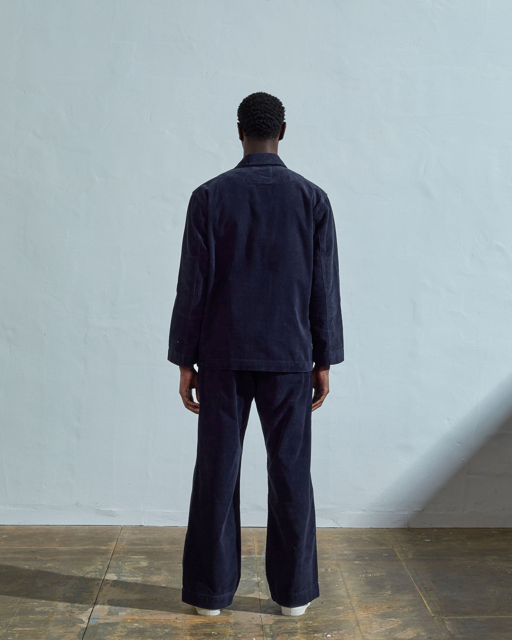 Full length back view of model wearing midnight-blue cord 3006 blazer showing reinforced elbow area.
