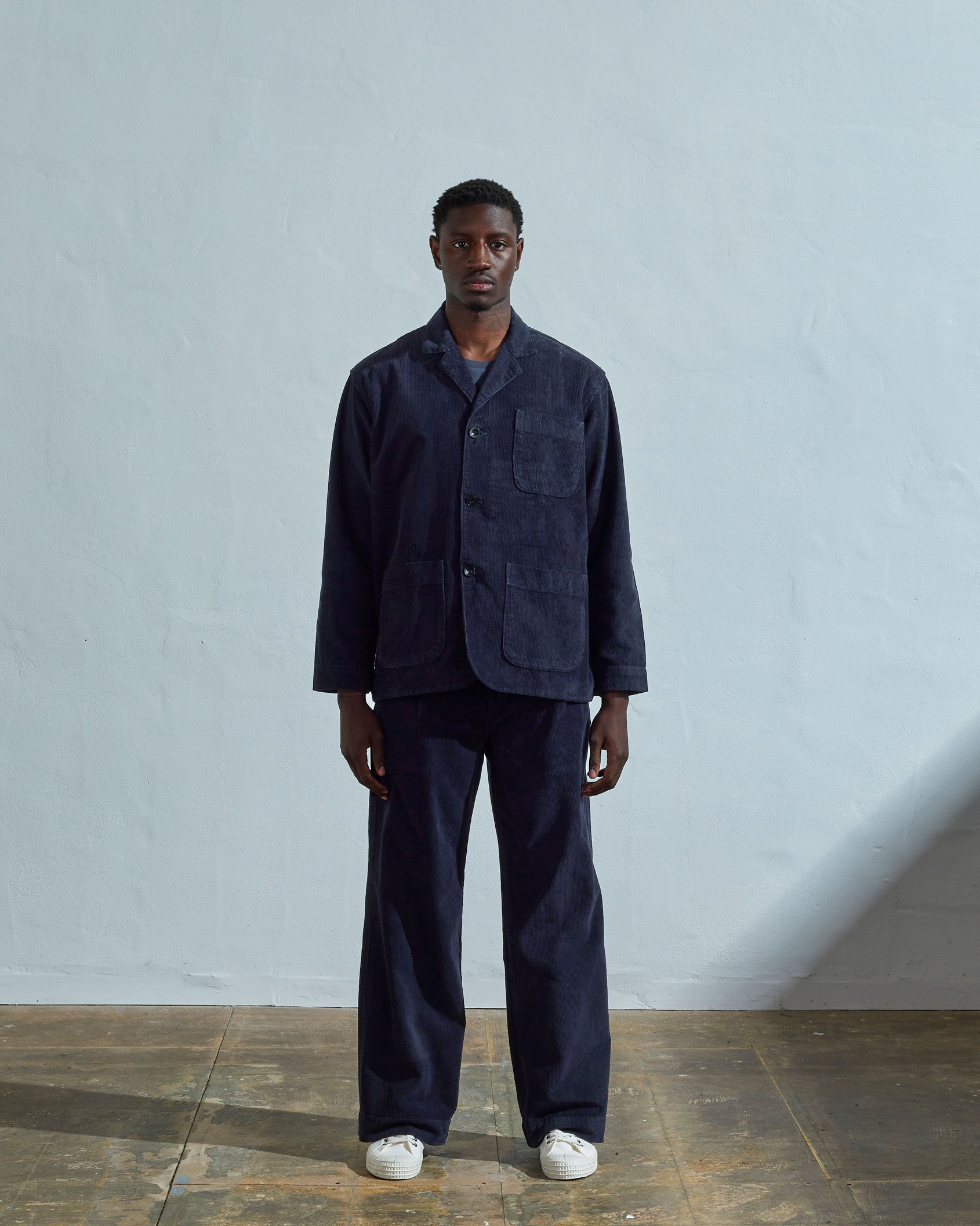 Full length front-view of model wearing midnight-blue cord 3006 blazer indicating simple, boxy design.