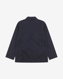 Reverse of deep blue buttoned organic cotton-twill blazer from Uskees showing reinforced elbows and boxy silhouette.