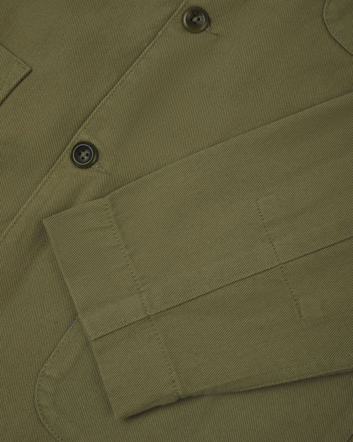 Closer detail view of patch pockets, cuff detailing, corozo buttons and extra durable weave of the organic cotton drill fabric.