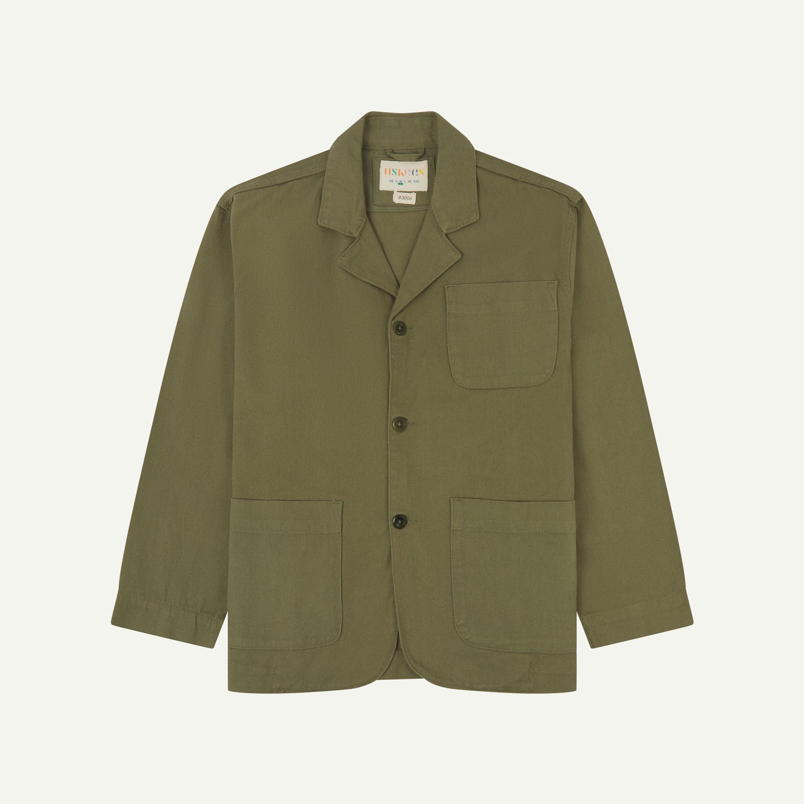 Moss-green buttoned organic cotton-drill blazer from Uskees with clear view of three patch pockets and Uskees branding label.