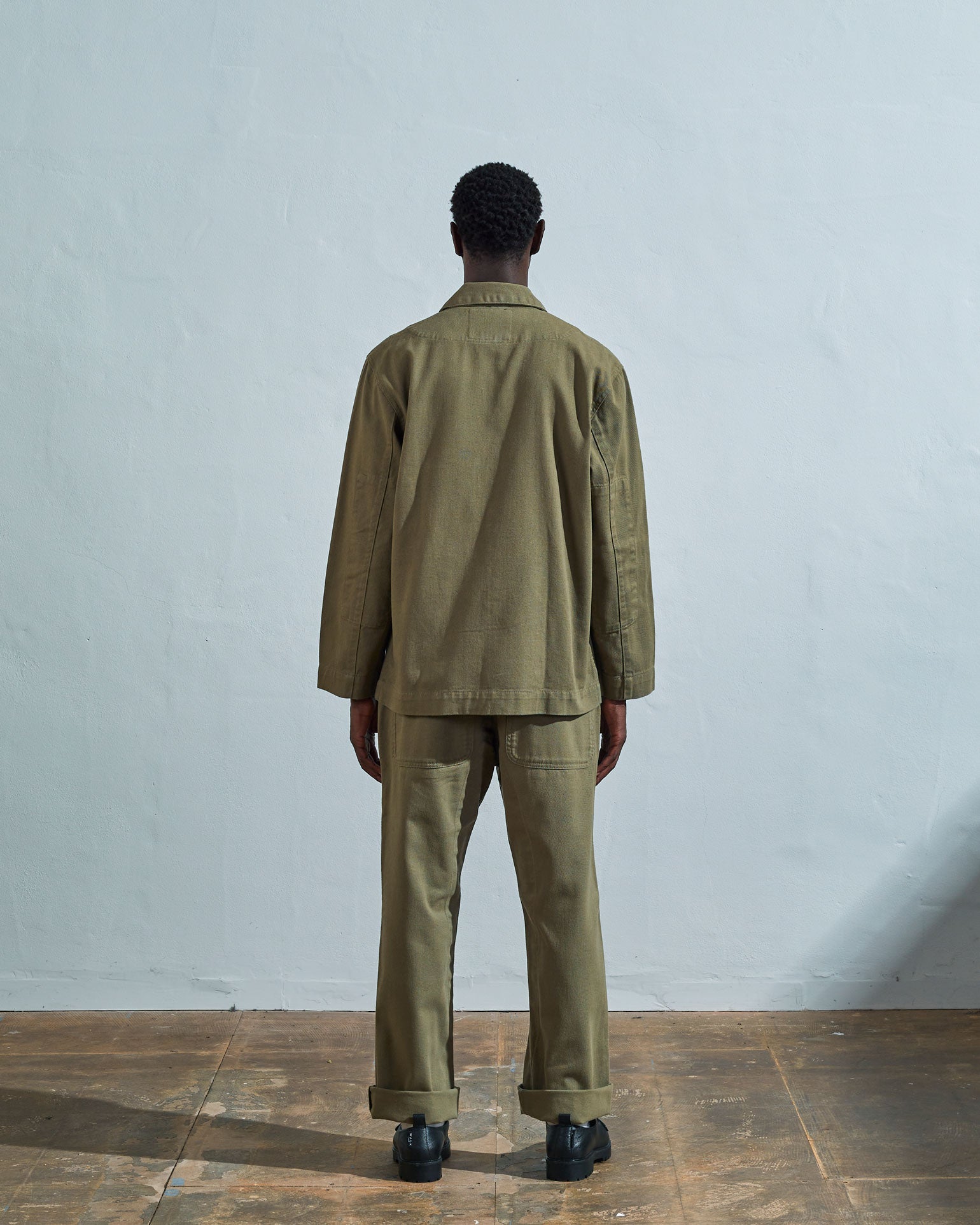 Reverse view of Uskees #3006 moss-green organic cotton drill blazer with view of reinforced elbows.
